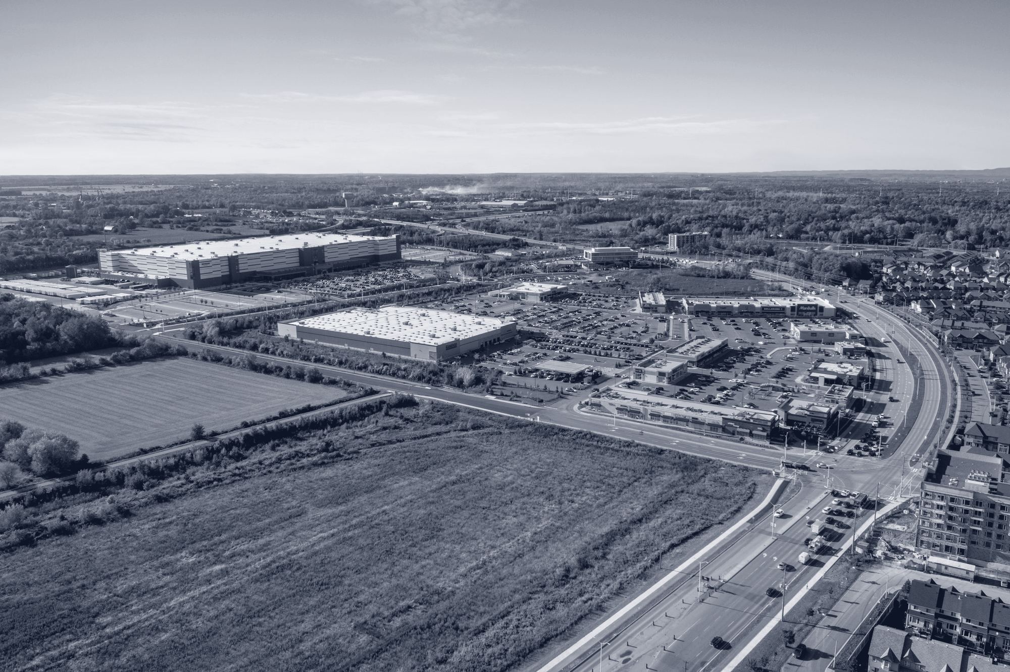 Aerial view of open land next to a logistics park